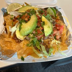 Taco Crave - Piled High nachos with queso & all the toppings