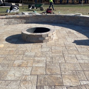 G2 Landscape - Paver Patio with Fireplace. Bench with pillars on each side with lighting - Landscaping Near Me G2 Landscape - Paver Patio with Fireplace. Bench with pillars on each side with lighting - Landscaping Near Me