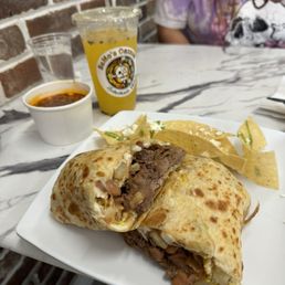 Breakfast Burrito Classico with Birria and a side of consume Breakfast Burrito Classico with Birria and a side of consume