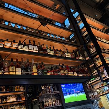 Puesto Santa Clara - Some of the many racks of liquor over and around the bar - Mexican Near Me - Santa Clara, California Puesto Santa Clara - Some of the many racks of liquor over and around the bar - Mexican Near Me - Santa Clara, California
