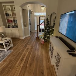 Floors For Living - Living room and entry flooring with Revwood Sunbathed Pecan laminate.