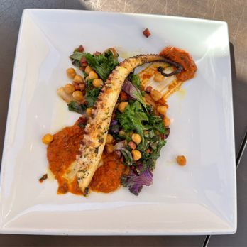 Cafe Sevilla - GRILLED PULPO ROMESCO Octopus, chorizo, kale, shallots, chickpeas, romesco sauce $24 - Spanish Near Me - Costa Mesa, California