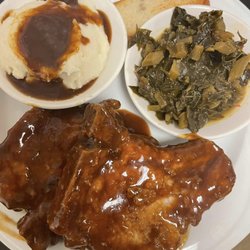 Smothered Pork chops wi/Collard greens and Mashed potatoes and gravy.