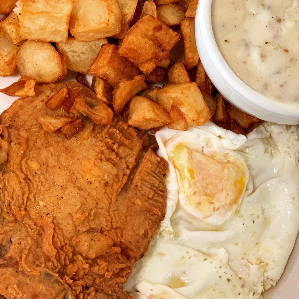 Pork chop with 2 eggs over-medium, side of sausage gravy and seasoned potatoes. Pork chop with 2 eggs over-medium, side of sausage gravy and seasoned potatoes.