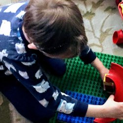Mary Jo's Daycare - Child playing with Duplo Legos