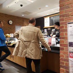 a man standing at a counter a man standing at a counter