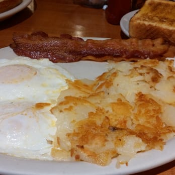 American Table - This is the Traditional breakfast. Two eggs over easy, bacon, American potatoes and Texas toast. Delicious! - Breakfast & Brunch Near Me - Warsaw, Indiana