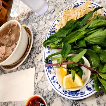 Pho 97 One - a plate of noodles and a bowl of soup - Vietnamese Near Me - Kapolei, Hawaii Pho 97 One - a plate of noodles and a bowl of soup - Vietnamese Near Me - Kapolei, Hawaii