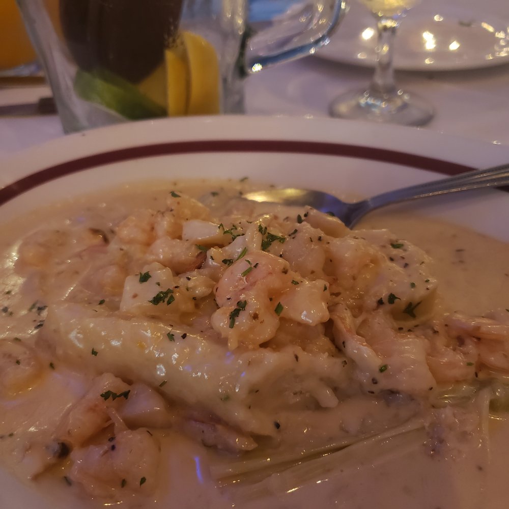 Lola's - Seafood tamale with an empty pitcher of Sangria in the back ground. - Spanish Near Me - Hoboken, New Jersey Lola's - Seafood tamale with an empty pitcher of Sangria in the back ground. - Spanish Near Me - Hoboken, New Jersey