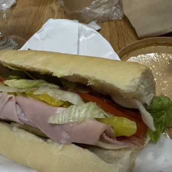 Decosmo Italian Market - #9 La Famiglia. Ultimate Italian - ham, salami, capicola, mortadella, provolone, tomato, onion, lettuce, pepperoncini, house dressing. - International Grocery Near Me - Pinellas Park, Florida