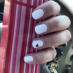 White nails with hand-painted heart White nails with hand-painted heart