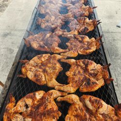 El Pollito Vaquero - Whole chickens slow cooking on the grill