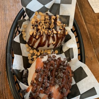 Glazed Over Donuts - Top: glaze with chocolate drizzle and peanut butter chips, Bottom: glaze with strawberry drizzle and chocolate chip - Donuts Near Me - Beacon, New York