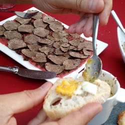 Barriere Truffes - Carpaccio covered in shaved truffles a l'ete (summer truffles) and spreading some of that lovely runny oeufs cochette aux truffles on bread.