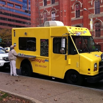 Lasagna Plus - a woman ordering food from a food truck - Street Vendors Near Me