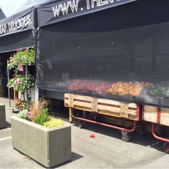 The Root Cellar - a row of planters in front of a building - Grocery Near Me - Saanich, British Columbia