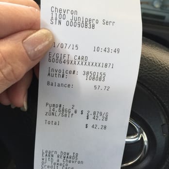 Chevron - a person holding a receipt in their hand - Gas Stations Near Me - San Francisco, California
