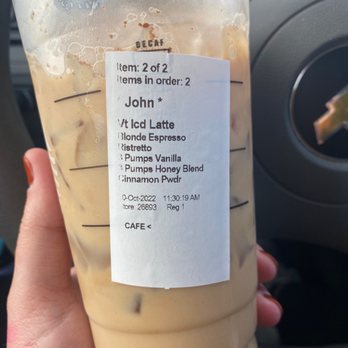 Starbucks - a hand holding a cup of iced coffee - Coffee & Tea Near Me - Lansing, Michigan