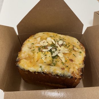 Sweet Talk Cafe - Honey garlic brick toast. Buttered garlic toast, cheese blend, honey drizzle, chopped almonds, parsley. - Cafes Near Me - Apex, North Carolina