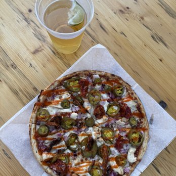 The Bank - Hot chic pizza with extra onion and jalapeños and the cross island lager. Both on happy hour special! $10 pizza and $3.50 beer. - Beer Gardens Near Me - Hilton Head Island, South Carolina The Bank - Hot chic pizza with extra onion and jalapeños and the cross island lager. Both on happy hour special! $10 pizza and $3.50 beer. - Beer Gardens Near Me - Hilton Head Island, South Carolina
