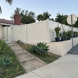 Huntington Fence And Steel - Tan vinyl fence with a gate