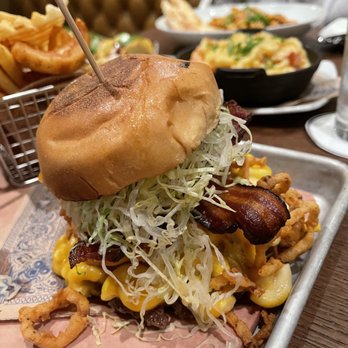 Guy Fieri's Cherokee Kitchen + Bar - Bacon mac-n-cheese burger - New American Near Me - Cherokee, North Carolina Guy Fieri's Cherokee Kitchen + Bar - Bacon mac-n-cheese burger - New American Near Me - Cherokee, North Carolina