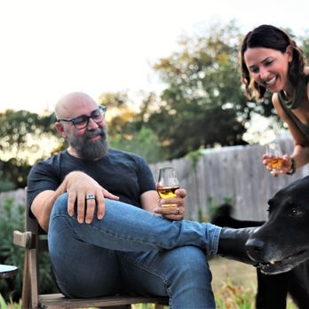 Old Humble Distilling Company - a man and woman with a dog - Distilleries Near Me - Humble, Texas Old Humble Distilling Company - a man and woman with a dog - Distilleries Near Me - Humble, Texas
