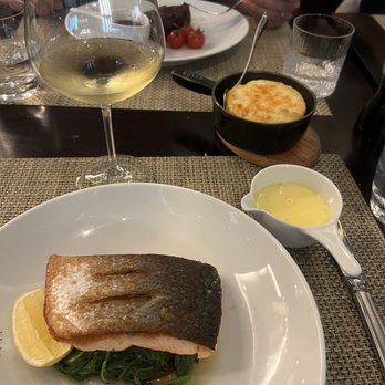 JW Steakhouse - Salmon entree served with sautéed spinach and a lovely lemon sauce. Side potato au gratin. - Steakhouses Near Me - London, XGL