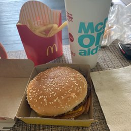 a hamburger and a drink on a table a hamburger and a drink on a table