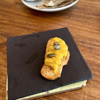 La Alcoba Azul - Amuse bouche of pumpkin hummus topped with pepitas. - Tapas Bars Near Me - Barcelona, B La Alcoba Azul - Amuse bouche of pumpkin hummus topped with pepitas. - Tapas Bars Near Me - Barcelona, B
