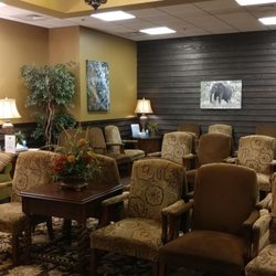 The waiting area is like sitting in a log cabin around a giant fireplace. Very cozy