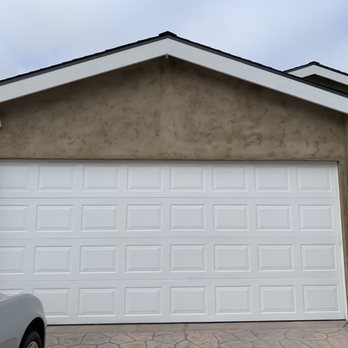 MR STUCCO MAN - a garage with a white garage door - General Contractors Near Me MR STUCCO MAN - a garage with a white garage door - General Contractors Near Me