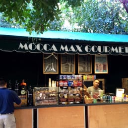 a man standing in front of a coffee shop a man standing in front of a coffee shop