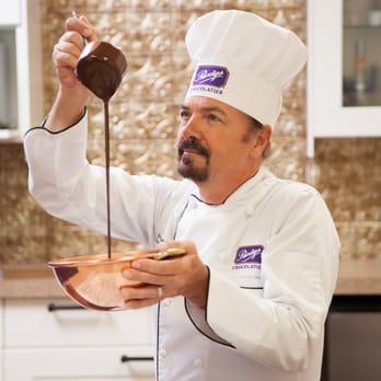 Purdys Chocolatier - a chef pouring chocolate into a bowl - Chocolatiers & Shops Near Me - Oshawa, Ontario