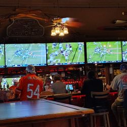 The Log Cabin - 5 TVs wide across the bar.  Probably another 12 scattered indoors and outdoors.