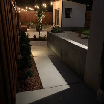 ARKLAND - a patio at night - Landscaping Near Me ARKLAND - a patio at night - Landscaping Near Me