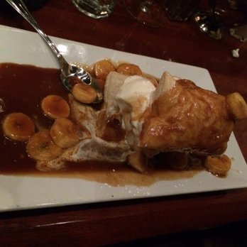 Winston's Grille - Banana's Foster with puff pastry, on top of vanilla ice cream, swimming in a caramel sauce and banana cooked with captain Morgan. - American Near Me - Raleigh, North Carolina Winston's Grille - Banana's Foster with puff pastry, on top of vanilla ice cream, swimming in a caramel sauce and banana cooked with captain Morgan. - American Near Me - Raleigh, North Carolina