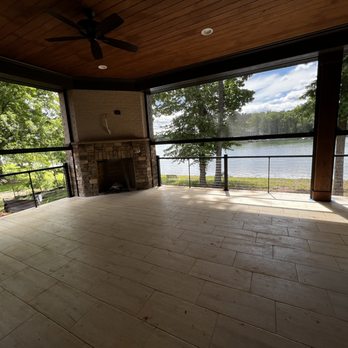 Kennedy Enterprise - a patio with a fireplace and a view of a lake - General Contractors Near Me - Mooresville, North Carolina Kennedy Enterprise - a patio with a fireplace and a view of a lake - General Contractors Near Me - Mooresville, North Carolina