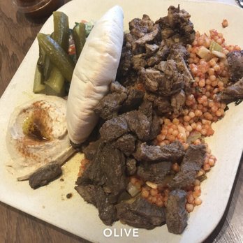 Olive Mediterranean Grill - OMG Plate with hummus, couscous, half chicken half steak shawarma, pickles, and pita break - Mediterranean Near Me - Chicago, Illinois