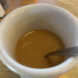 a cup of coffee with a spoon in it a cup of coffee with a spoon in it