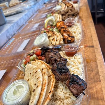 Pita Gyros - a variety of food on a table - Food Stands Near Me - San Francisco, California Pita Gyros - a variety of food on a table - Food Stands Near Me - San Francisco, California