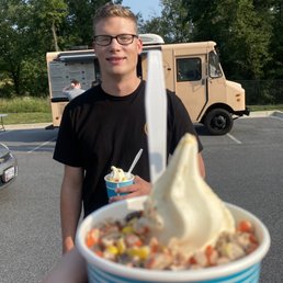 a man holding a cup of ice cream