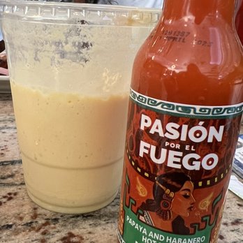 Malecon Restaurant - Mango shake and hot sauce at table - Dominican Near Me - New York, New York