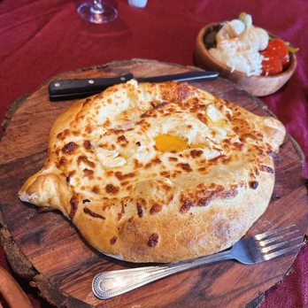 Cafe Tbilisi - Khachapuri with an egg on top - Georgian Near Me - Delray Beach, Florida