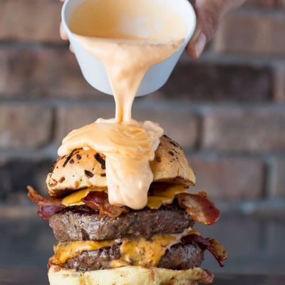 Photo of Tucker Duke's - Deerfield Beach - Deerfield Beach, FL, US. The Big Hoss
Two 6oz Patty's, 4 slices of American cheese, 4 slices of bacon, on a toasted onion roll all covered in cheese sauce!