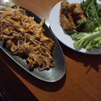 Pho 4 Star - Chicken pad thai on shiny new elongated plate paired with Vietnamese dried spring rolls. Yum. Yum. - Vietnamese Near Me - Universal City, Texas