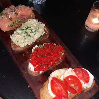 Postino Annex - From left to right: smoked salmon, artichoke, goat cheese and piquillo pepper, tomato and mozzarella - Wine Bars Near Me - Tempe, Arizona Postino Annex - From left to right: smoked salmon, artichoke, goat cheese and piquillo pepper, tomato and mozzarella - Wine Bars Near Me - Tempe, Arizona