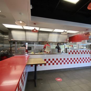 Five Guys - a restaurant kitchen with red and white checkered counter tops - Burgers Near Me - Glastonbury, Connecticut