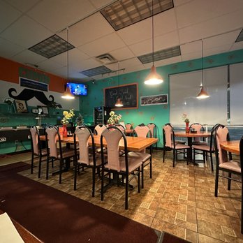 Cumin - a dining room with tables and chairs - Indian Near Me - Kalamazoo, Michigan Cumin - a dining room with tables and chairs - Indian Near Me - Kalamazoo, Michigan