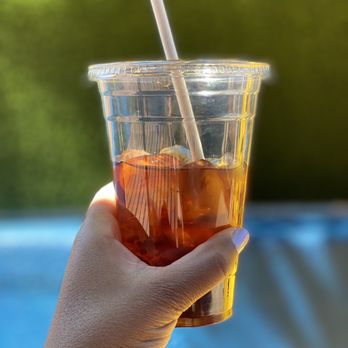 Creative Grounds DC - a hand holding a plastic cup of iced tea - Art Classes Near Me - Washington, DC, District of Columbia